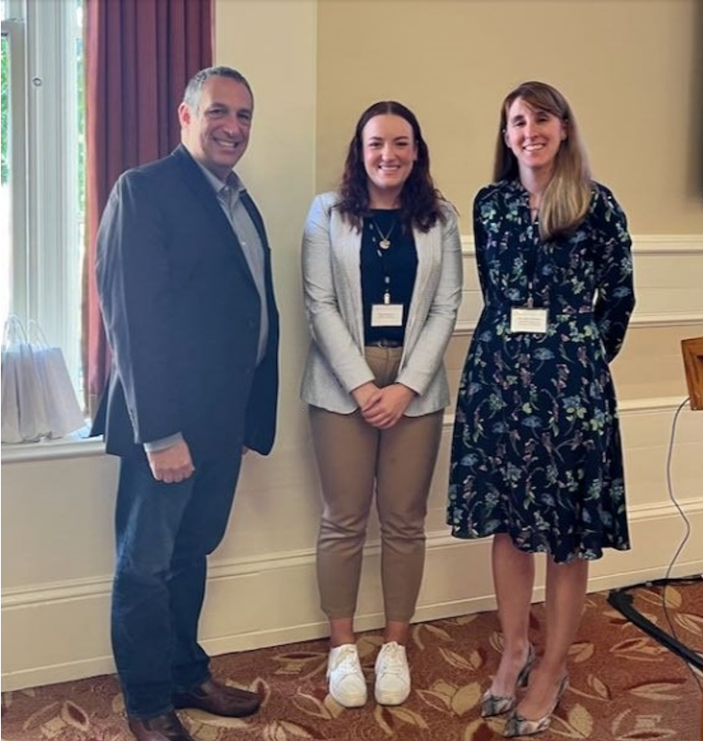 "Paige Moncure posing for a photo with PQI Director Adam Leibovich and Best Poster Committee Chair Susan Fullerton after winning a best poster award among several winners."